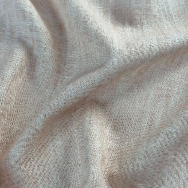 Close view of plain off-white fabric with a fine, open woven grid, gathered into broad diagonal folds.