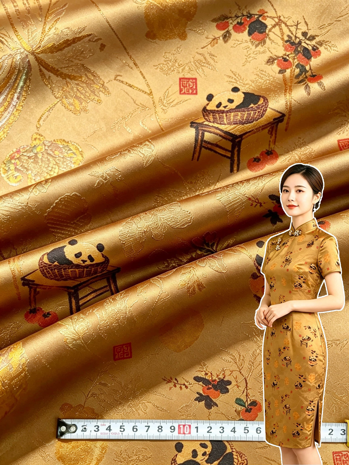 Close-up of glossy golden-brown fabric arranged in broad folds, patterned with small pandas in baskets on tables, red fruit, foliage, and red seal-like marks; a model in a matching long dress and a measuring tape are also visible.