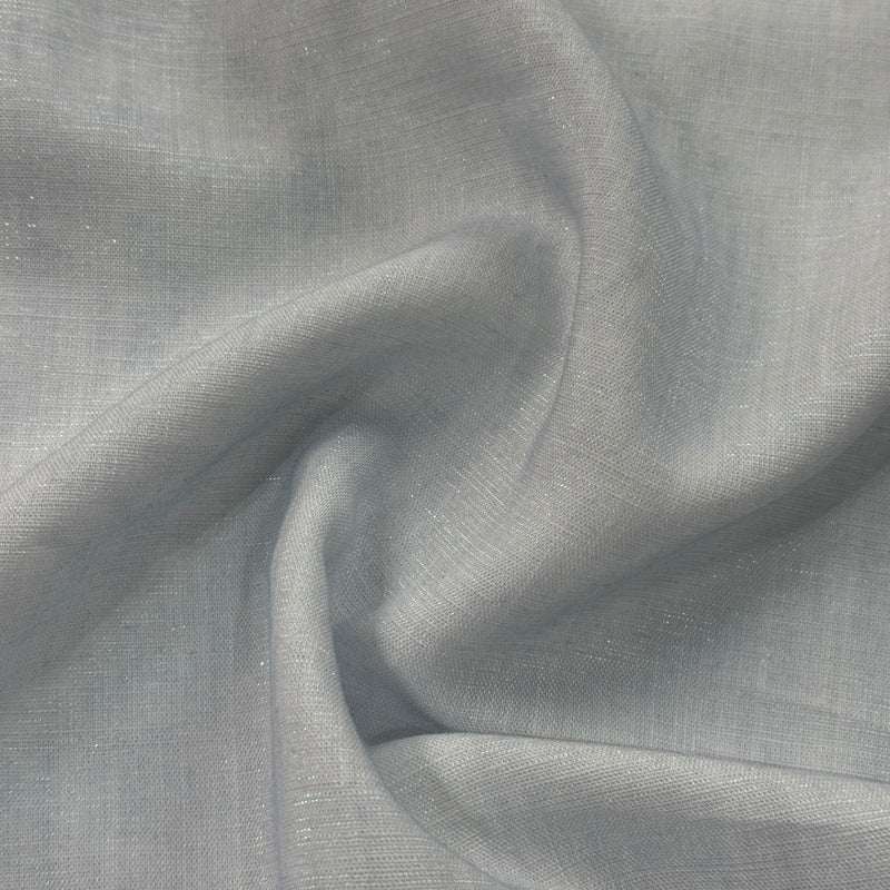 Light gray fabric arranged in flowing folds, with a fine, even woven texture and subtle reflective specks.