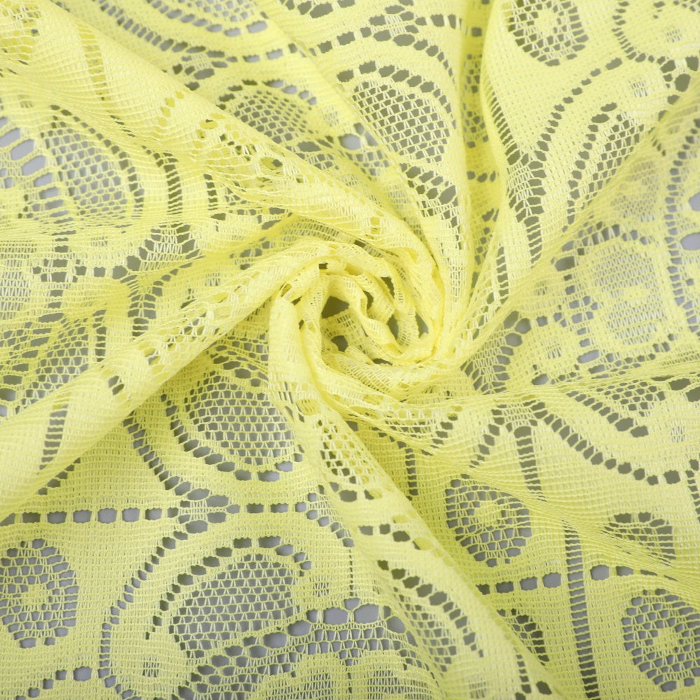 Pale yellow openwork lace fabric is spread across the frame, with repeating floral and geometric motifs and a gathered twist near the center.