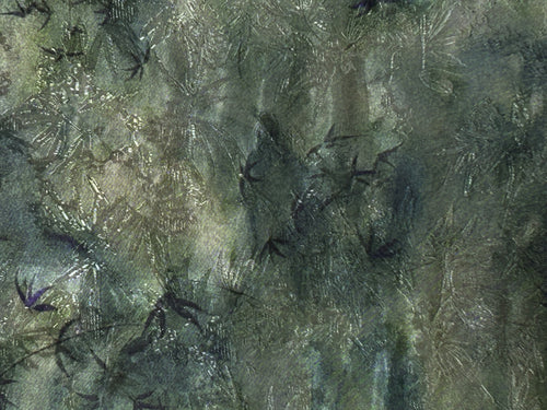 Close-up of a dark green and gray textile with an irregular mottled pattern and scattered fine, pale scratch-like lines.