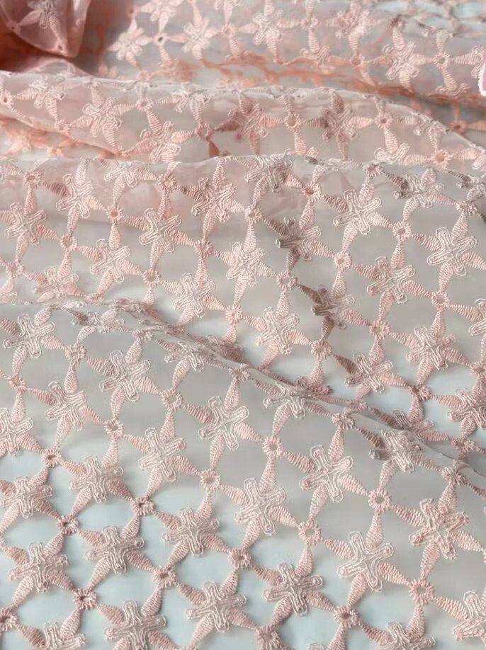Embroidered lattice on fine tulle, seen close